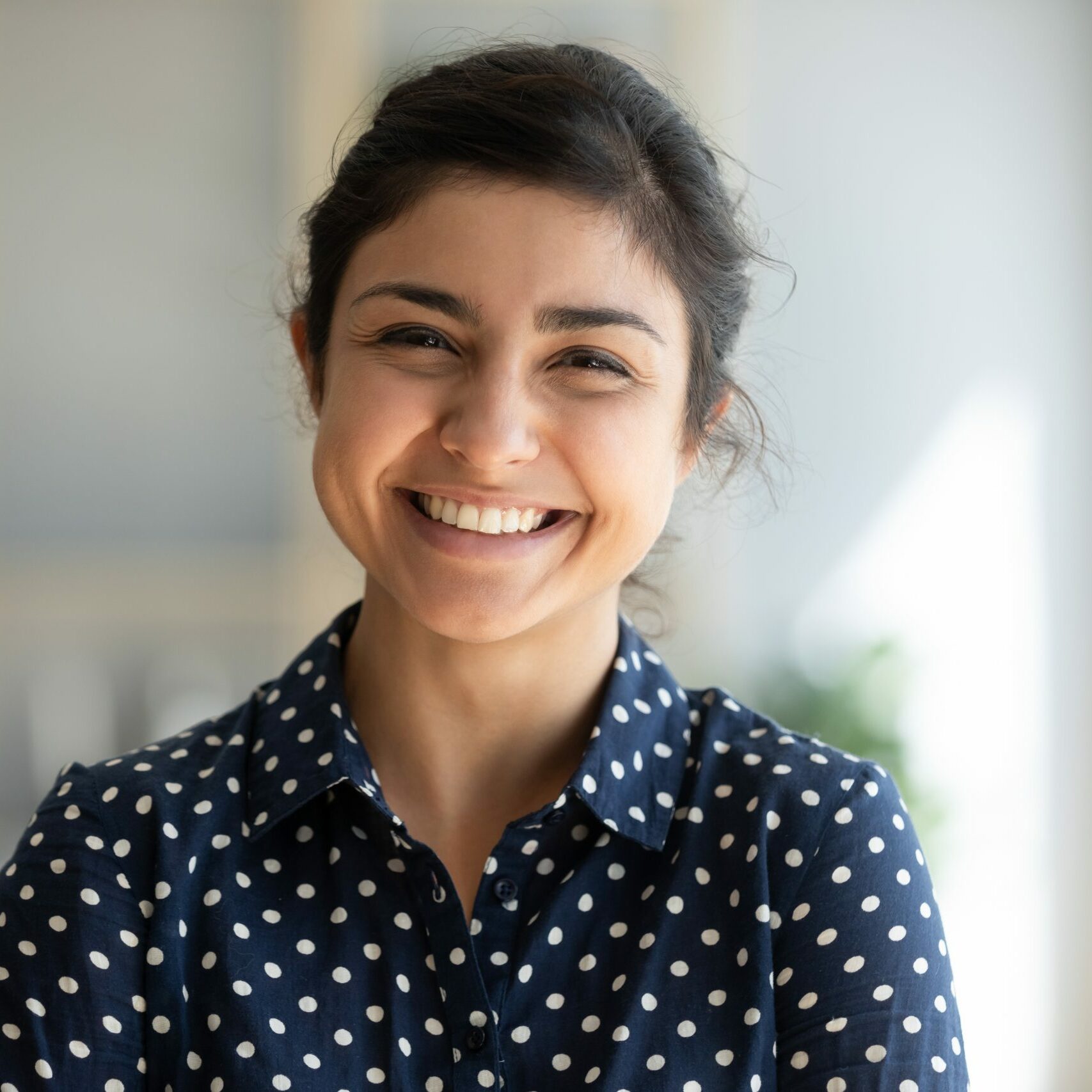 Cheerful beautiful indian girl student professional standing at home in office looking at camera, happy confident entrepreneur hindu lady laughing face posing alone, head shot close up view portrait
